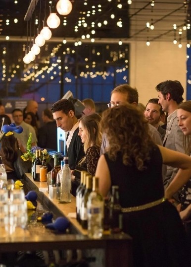 Guests at the bar under string lights