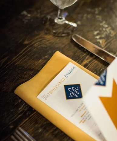 Branded place card on a gold napkin