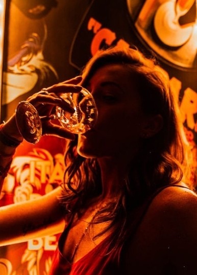 Guest drinking under amber light