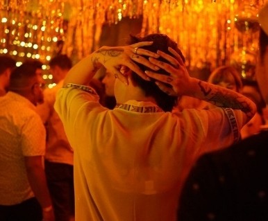 Silent disco dancer under gold light
