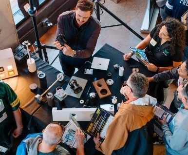 Overhead view of attendees at a product table