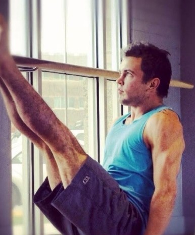 Instructor in a held pose by the window