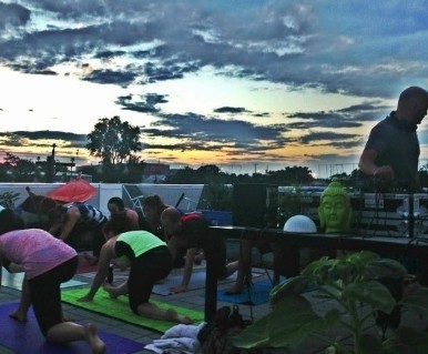 Class at sunset beside a Buddha statue